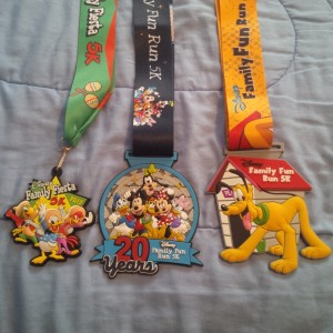 Walt Disney World Family 5k "medals" from 2012, 2013, and 2014