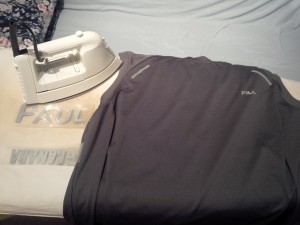 Bare shirt, iron, and decals ready to apply