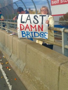 Lady holding "Last Damn Bridge" sign before the 138th street bridge (I think I got it off Facebook)