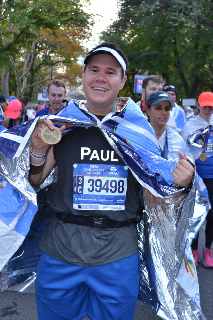 Showing off my medal in the finish chute
